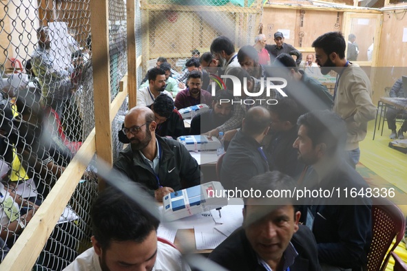 Election officials count votes for the local assembly elections at a counting center in Srinagar, Jammu and Kashmir, on October 8, 2024. 