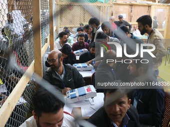 Election officials count votes for the local assembly elections at a counting center in Srinagar, Jammu and Kashmir, on October 8, 2024. (