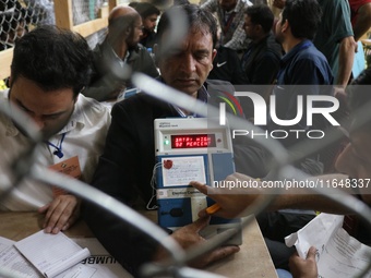 Election officials count votes for the local assembly elections at a counting center in Srinagar, Jammu and Kashmir, on October 8, 2024. (