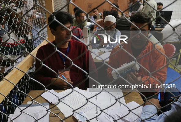 Election officials count votes for the local assembly elections at a counting center in Srinagar, Jammu and Kashmir, on October 8, 2024. 