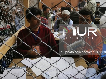 Election officials count votes for the local assembly elections at a counting center in Srinagar, Jammu and Kashmir, on October 8, 2024. (