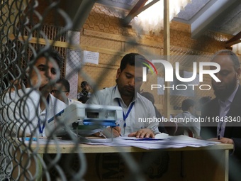 Election officials count votes for the local assembly elections at a counting center in Srinagar, Jammu and Kashmir, on October 8, 2024. (