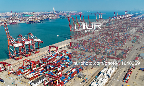 Cargo ships load and unload containers in the Qingdao area of the China (Shandong) Pilot Free Trade Zone in Qingdao, China, on October 8, 20...