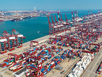 Cargo ships load and unload containers in the Qingdao area of the China (Shandong) Pilot Free Trade Zone in Qingdao, China, on October 8, 20...