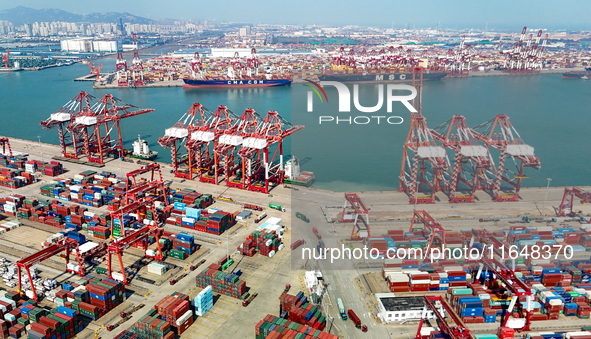 Cargo ships load and unload containers in the Qingdao area of the China (Shandong) Pilot Free Trade Zone in Qingdao, China, on October 8, 20...