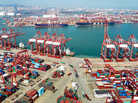 Cargo ships load and unload containers in the Qingdao area of the China (Shandong) Pilot Free Trade Zone in Qingdao, China, on October 8, 20...