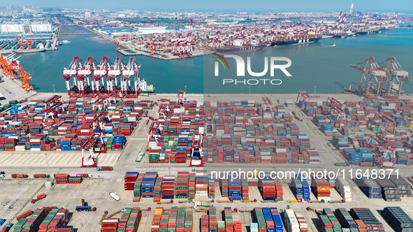 Cargo ships load and unload containers in the Qingdao area of the China (Shandong) Pilot Free Trade Zone in Qingdao, China, on October 8, 20...