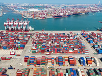 Cargo ships load and unload containers in the Qingdao area of the China (Shandong) Pilot Free Trade Zone in Qingdao, China, on October 8, 20...