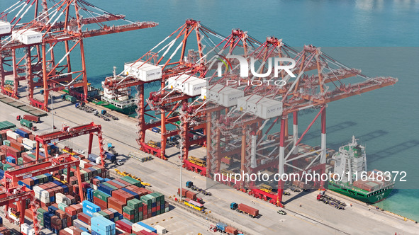 Cargo ships load and unload containers in the Qingdao area of the China (Shandong) Pilot Free Trade Zone in Qingdao, China, on October 8, 20...