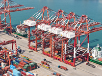 Cargo ships load and unload containers in the Qingdao area of the China (Shandong) Pilot Free Trade Zone in Qingdao, China, on October 8, 20...