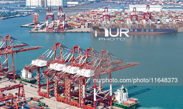 Cargo ships load and unload containers in the Qingdao area of the China (Shandong) Pilot Free Trade Zone in Qingdao, China, on October 8, 20...