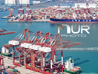 Cargo ships load and unload containers in the Qingdao area of the China (Shandong) Pilot Free Trade Zone in Qingdao, China, on October 8, 20...