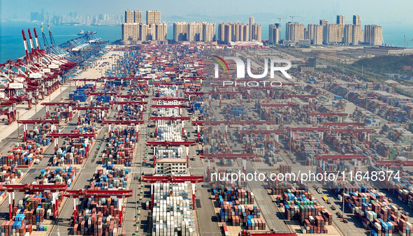 Cargo ships load and unload containers in the Qingdao area of the China (Shandong) Pilot Free Trade Zone in Qingdao, China, on October 8, 20...