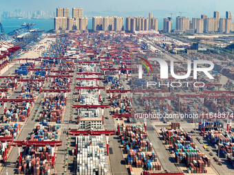 Cargo ships load and unload containers in the Qingdao area of the China (Shandong) Pilot Free Trade Zone in Qingdao, China, on October 8, 20...