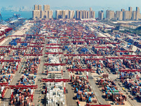 Cargo ships load and unload containers in the Qingdao area of the China (Shandong) Pilot Free Trade Zone in Qingdao, China, on October 8, 20...