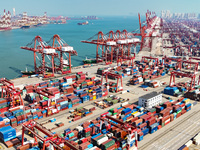 Cargo ships load and unload containers in the Qingdao area of the China (Shandong) Pilot Free Trade Zone in Qingdao, China, on October 8, 20...