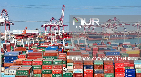 Cargo ships load and unload containers in the Qingdao area of the China (Shandong) Pilot Free Trade Zone in Qingdao, China, on October 8, 20...