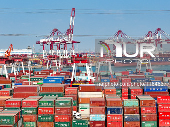 Cargo ships load and unload containers in the Qingdao area of the China (Shandong) Pilot Free Trade Zone in Qingdao, China, on October 8, 20...