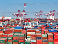 Cargo ships load and unload containers in the Qingdao area of the China (Shandong) Pilot Free Trade Zone in Qingdao, China, on October 8, 20...