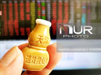 A shareholder checks the stock market with suxiao jiuxin pills (medicine for the heart) in Qingdao, China, on October 8, 2024. (