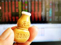 A shareholder checks the stock market with suxiao jiuxin pills (medicine for the heart) in Qingdao, China, on October 8, 2024. (