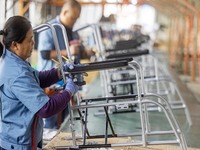 Workers rush to make Japanese-ordered products on the wheelchair production line of Zhongjin Medical Equipment Taizhou Co., Ltd. in Taizhou,...