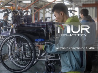 Workers rush to make Japanese-ordered products on the wheelchair production line of Zhongjin Medical Equipment Taizhou Co., Ltd. in Taizhou,...