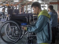 Workers rush to make Japanese-ordered products on the wheelchair production line of Zhongjin Medical Equipment Taizhou Co., Ltd. in Taizhou,...