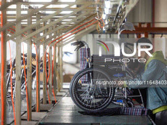 Workers rush to make Japanese-ordered products on the wheelchair production line of Zhongjin Medical Equipment Taizhou Co., Ltd. in Taizhou,...