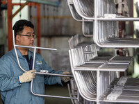 Workers rush to make Japanese-ordered products on the wheelchair production line of Zhongjin Medical Equipment Taizhou Co., Ltd. in Taizhou,...