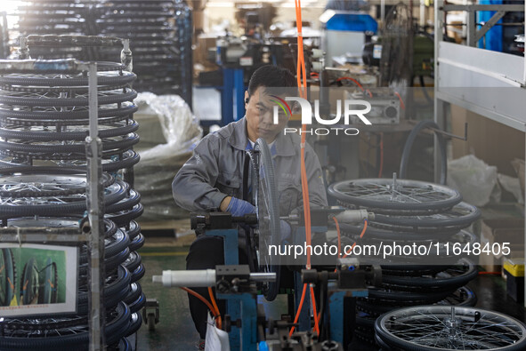 Workers rush to make Japanese-ordered products on the wheelchair production line of Zhongjin Medical Equipment Taizhou Co., Ltd. in Taizhou,...