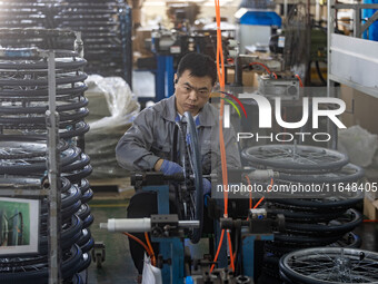 Workers rush to make Japanese-ordered products on the wheelchair production line of Zhongjin Medical Equipment Taizhou Co., Ltd. in Taizhou,...