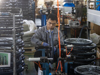 Workers rush to make Japanese-ordered products on the wheelchair production line of Zhongjin Medical Equipment Taizhou Co., Ltd. in Taizhou,...