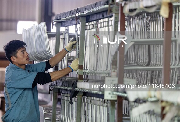 Workers rush to make Japanese-ordered products on the wheelchair production line of Zhongjin Medical Equipment Taizhou Co., Ltd. in Taizhou,...