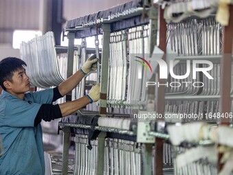 Workers rush to make Japanese-ordered products on the wheelchair production line of Zhongjin Medical Equipment Taizhou Co., Ltd. in Taizhou,...