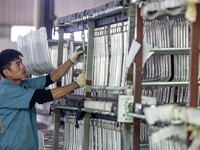 Workers rush to make Japanese-ordered products on the wheelchair production line of Zhongjin Medical Equipment Taizhou Co., Ltd. in Taizhou,...