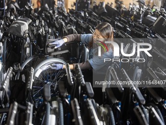 Workers rush to make Japanese-ordered products on the wheelchair production line of Zhongjin Medical Equipment Taizhou Co., Ltd. in Taizhou,...