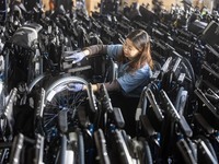 Workers rush to make Japanese-ordered products on the wheelchair production line of Zhongjin Medical Equipment Taizhou Co., Ltd. in Taizhou,...