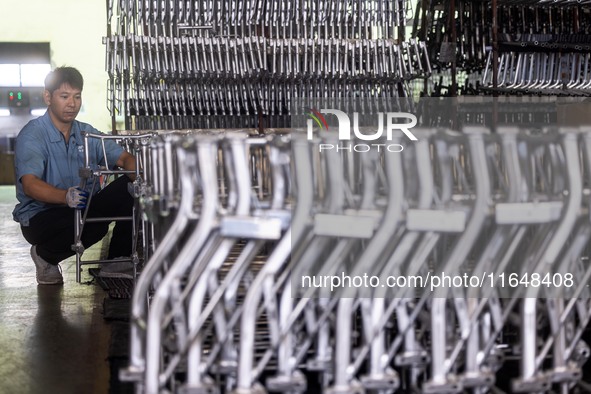 Workers rush to make Japanese-ordered products on the wheelchair production line of Zhongjin Medical Equipment Taizhou Co., Ltd. in Taizhou,...