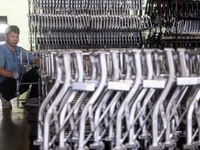 Workers rush to make Japanese-ordered products on the wheelchair production line of Zhongjin Medical Equipment Taizhou Co., Ltd. in Taizhou,...