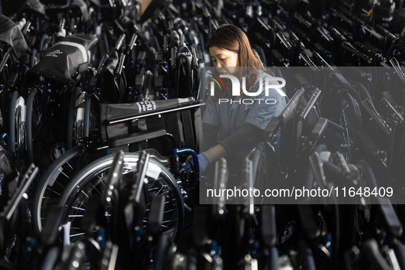 Workers rush to make Japanese-ordered products on the wheelchair production line of Zhongjin Medical Equipment Taizhou Co., Ltd. in Taizhou,...