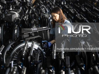 Workers rush to make Japanese-ordered products on the wheelchair production line of Zhongjin Medical Equipment Taizhou Co., Ltd. in Taizhou,...