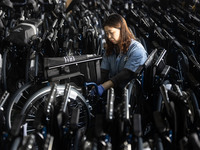 Workers rush to make Japanese-ordered products on the wheelchair production line of Zhongjin Medical Equipment Taizhou Co., Ltd. in Taizhou,...