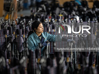 Workers rush to make Japanese-ordered products on the wheelchair production line of Zhongjin Medical Equipment Taizhou Co., Ltd. in Taizhou,...