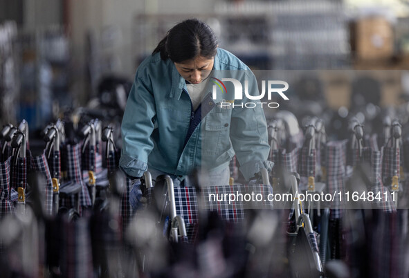 Workers rush to make Japanese-ordered products on the wheelchair production line of Zhongjin Medical Equipment Taizhou Co., Ltd. in Taizhou,...