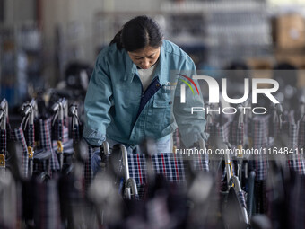 Workers rush to make Japanese-ordered products on the wheelchair production line of Zhongjin Medical Equipment Taizhou Co., Ltd. in Taizhou,...