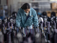 Workers rush to make Japanese-ordered products on the wheelchair production line of Zhongjin Medical Equipment Taizhou Co., Ltd. in Taizhou,...