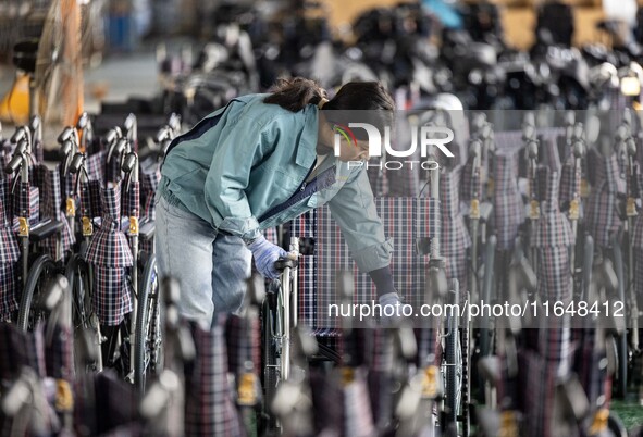 Workers rush to make Japanese-ordered products on the wheelchair production line of Zhongjin Medical Equipment Taizhou Co., Ltd. in Taizhou,...