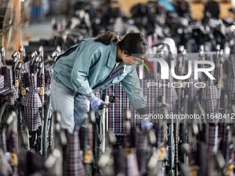 Workers rush to make Japanese-ordered products on the wheelchair production line of Zhongjin Medical Equipment Taizhou Co., Ltd. in Taizhou,...