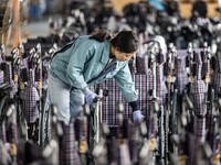 Workers rush to make Japanese-ordered products on the wheelchair production line of Zhongjin Medical Equipment Taizhou Co., Ltd. in Taizhou,...